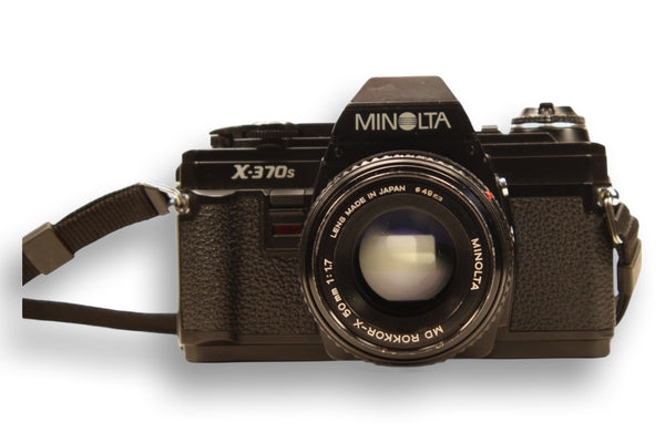 Front view of Minolta X-370S SLR film camera with Minolta Rokkor-X 50mm f/1.7 lens. A classic manual camera for film photography lovers.