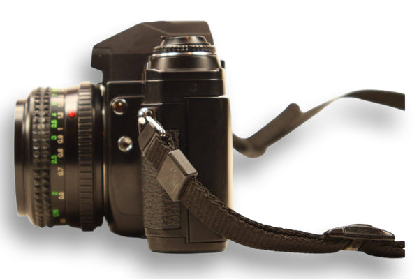 Side profile of Minolta X-370S 35mm film camera with attached strap and manual focus lens. Perfect for students and hobbyist photographers.