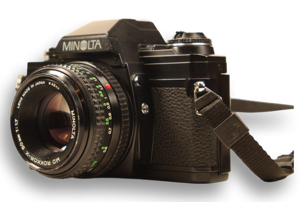 Angled view of Minolta X-370S SLR camera with 50mm f/1.7 lens, highlighting its manual controls and vintage design. Ideal for film photography students.