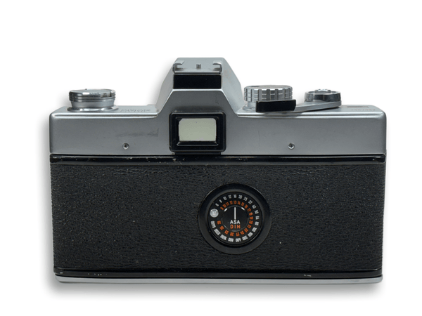 Vintage camera with a metallic top and black body on a white background